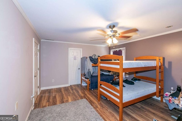 bedroom featuring dark wood-type flooring, ceiling fan, and crown molding