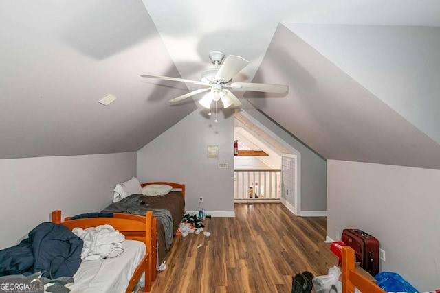 bedroom with lofted ceiling, dark wood-type flooring, and ceiling fan