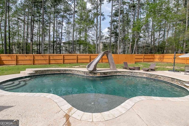 view of swimming pool with a water slide, sink, and a patio area