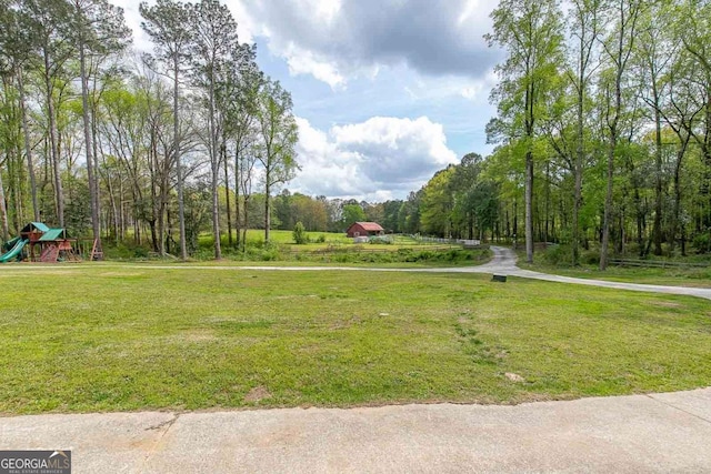 view of home's community featuring a yard and a playground