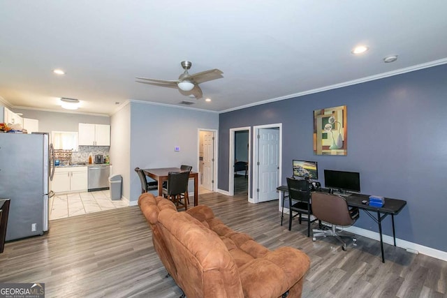 office space featuring crown molding, light hardwood / wood-style flooring, and ceiling fan