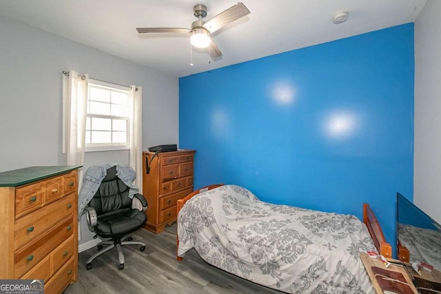 bedroom with hardwood / wood-style floors and ceiling fan