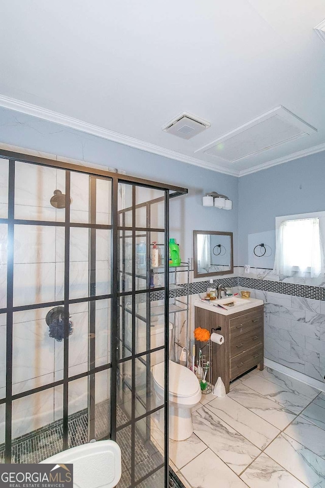 bathroom featuring crown molding, tile walls, vanity, and toilet