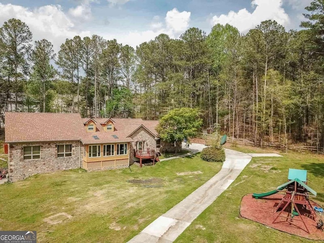 view of front of home featuring a playground and a front yard