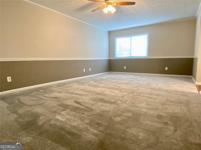 carpeted empty room with crown molding and ceiling fan