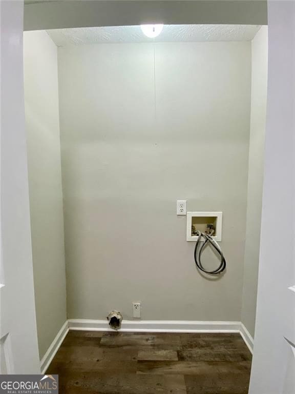 washroom with washer hookup, dark hardwood / wood-style flooring, electric dryer hookup, and a textured ceiling