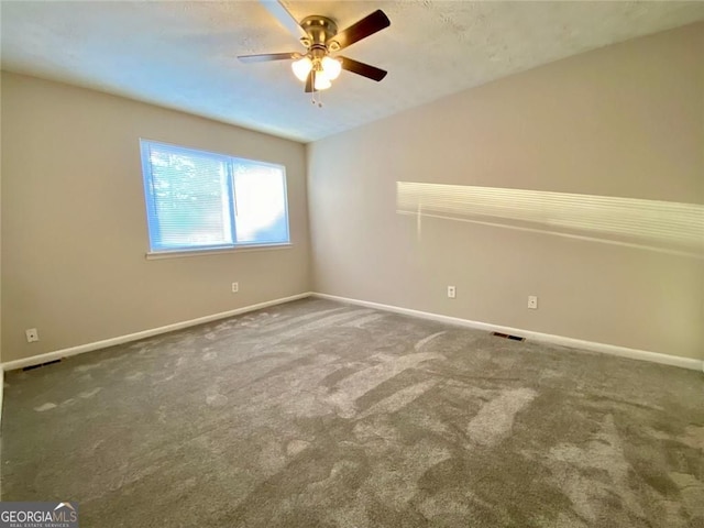 spare room featuring carpet, lofted ceiling, and ceiling fan