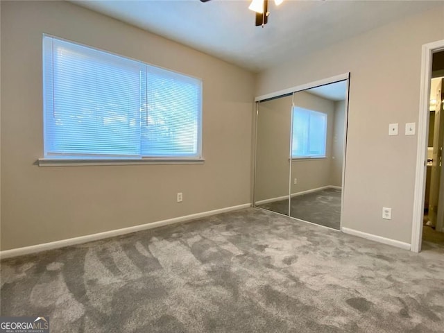 unfurnished bedroom featuring ceiling fan, carpet floors, and a closet