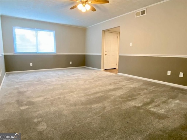 carpeted empty room with crown molding and ceiling fan