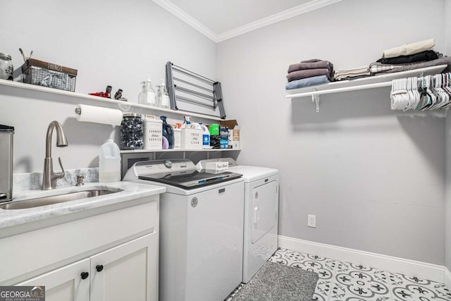 laundry room featuring sink, cabinets, ornamental molding, light tile patterned floors, and washer and clothes dryer