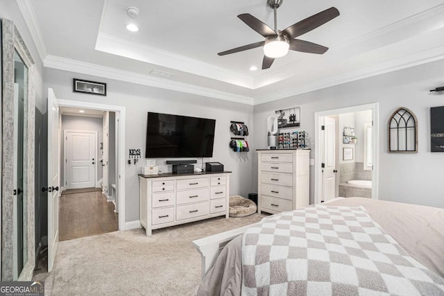 carpeted bedroom featuring crown molding, ceiling fan, connected bathroom, and a tray ceiling