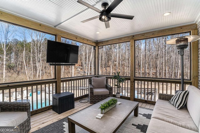 sunroom / solarium with wood ceiling and ceiling fan