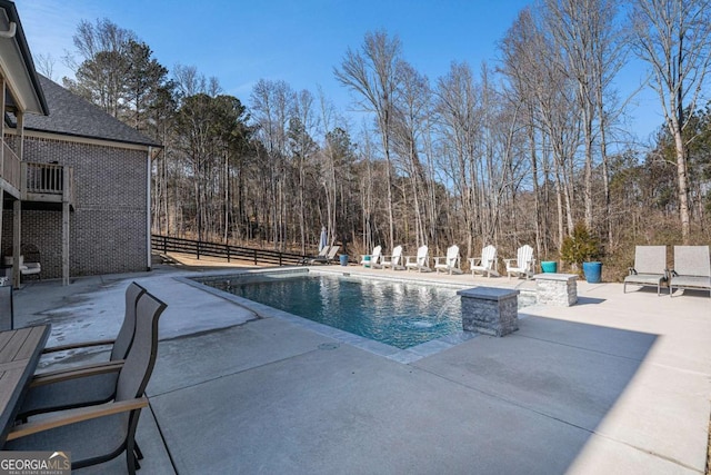 view of swimming pool featuring an outdoor fire pit and a patio area