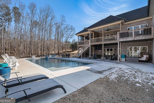 view of pool with a patio and ceiling fan