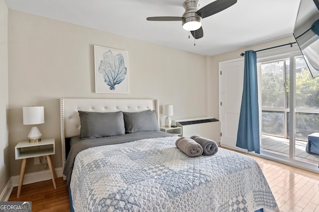 bedroom with ceiling fan, wood-type flooring, and access to exterior