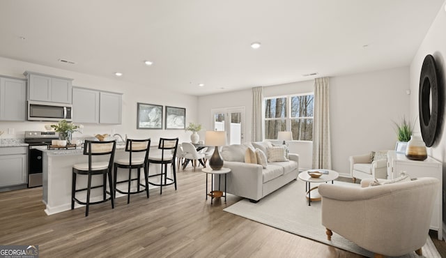 313 Sound Cir Unit 140, Stockbridge, GA 30281 - living room featuring wood finished floors and recessed lighting