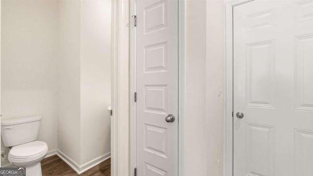 313 Sound Cir Unit 140, Stockbridge, GA 30281 - bathroom featuring toilet, wood finished floors, and baseboards