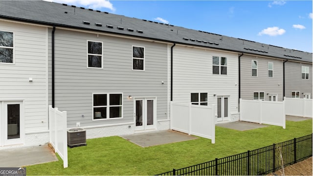 back of house featuring a patio area, a yard, french doors, and central AC