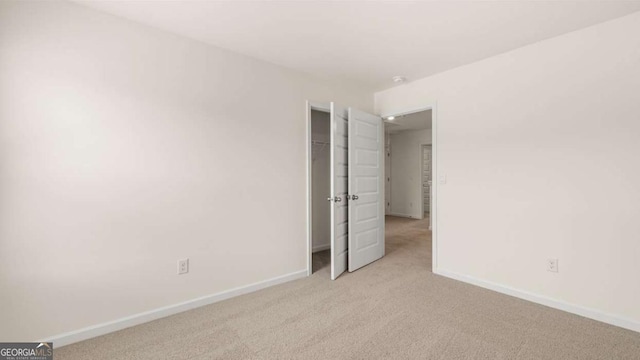 313 Sound Cir Unit 140, Stockbridge, GA 30281 - spare room featuring light carpet and baseboards