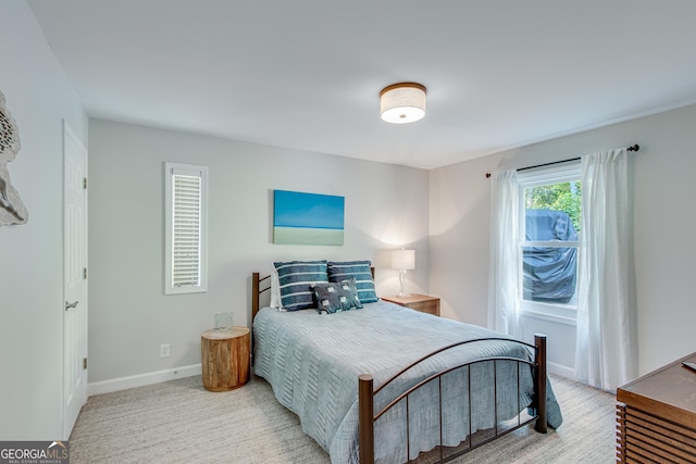 bedroom featuring light colored carpet