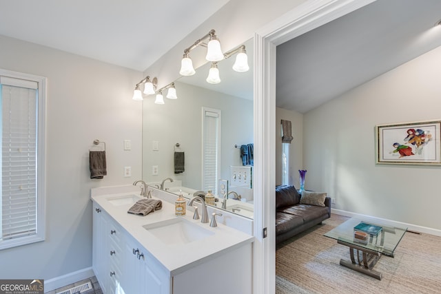 bathroom with vanity and vaulted ceiling