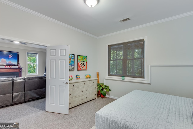 bedroom with ornamental molding and light carpet