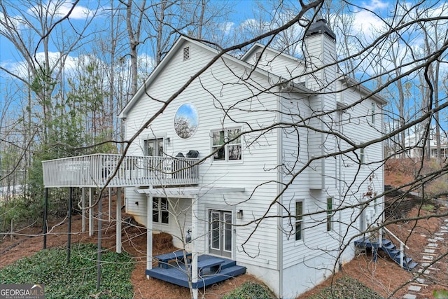 back of property featuring a wooden deck