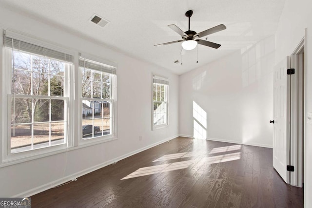 unfurnished room with dark hardwood / wood-style flooring and ceiling fan