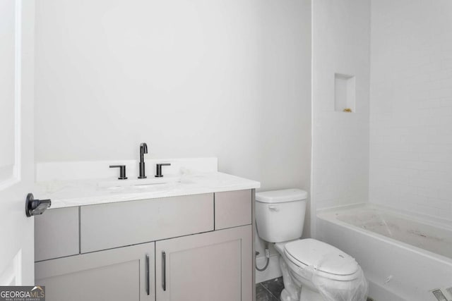 bathroom with vanity, a shower, and toilet