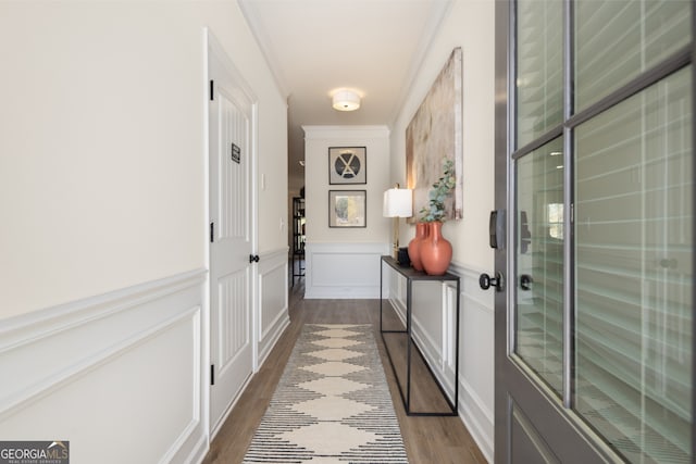 doorway to outside featuring ornamental molding and hardwood / wood-style floors