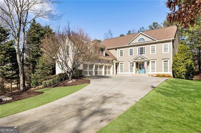 colonial-style house with a garage and a front lawn