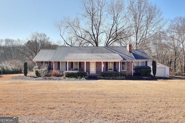 ranch-style house with an outbuilding, a garage, and a front yard