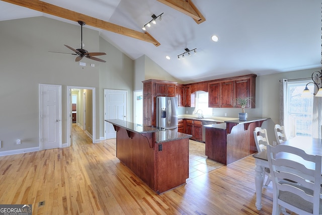 kitchen featuring appliances with stainless steel finishes, sink, a kitchen breakfast bar, and light hardwood / wood-style floors