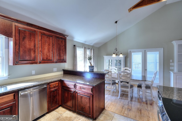 kitchen featuring pendant lighting, lofted ceiling, an inviting chandelier, stainless steel dishwasher, and kitchen peninsula