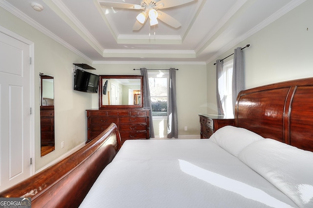 bedroom with a raised ceiling, crown molding, and ceiling fan