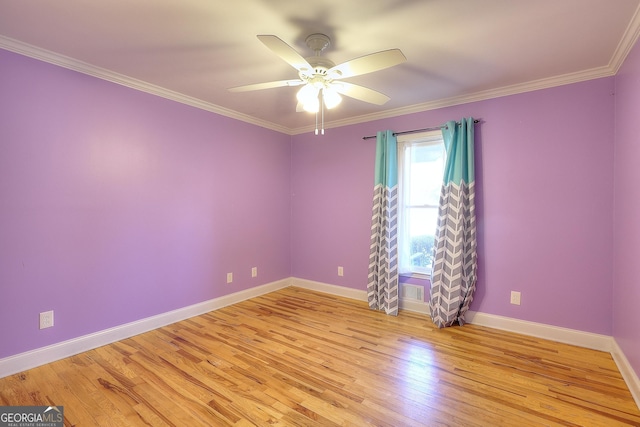 empty room with crown molding, ceiling fan, and light wood-type flooring