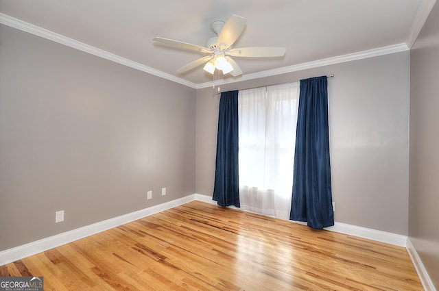 empty room with hardwood / wood-style flooring, crown molding, and ceiling fan