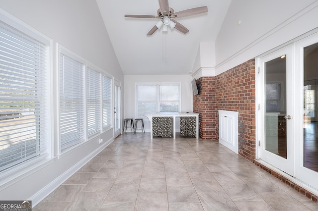 unfurnished sunroom with lofted ceiling and ceiling fan