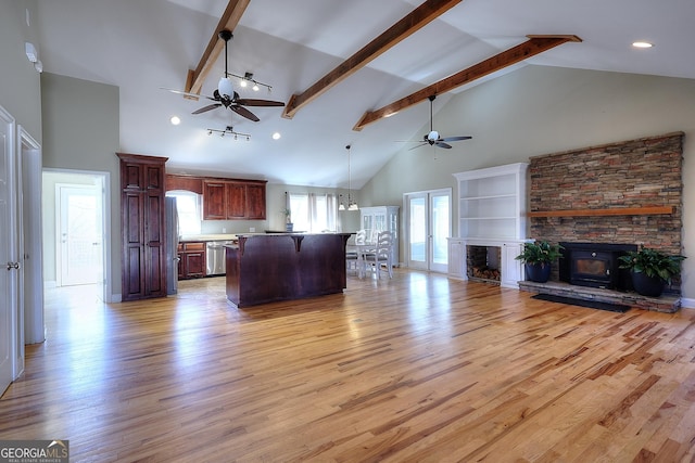 unfurnished living room with ceiling fan, beam ceiling, high vaulted ceiling, and light wood-type flooring