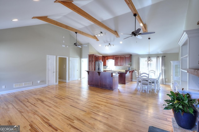 kitchen featuring beamed ceiling, stainless steel fridge with ice dispenser, ceiling fan with notable chandelier, and light hardwood / wood-style flooring