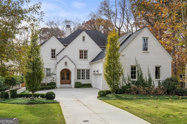 view of front of home with a front yard and french doors