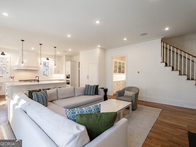 living room featuring hardwood / wood-style flooring and sink