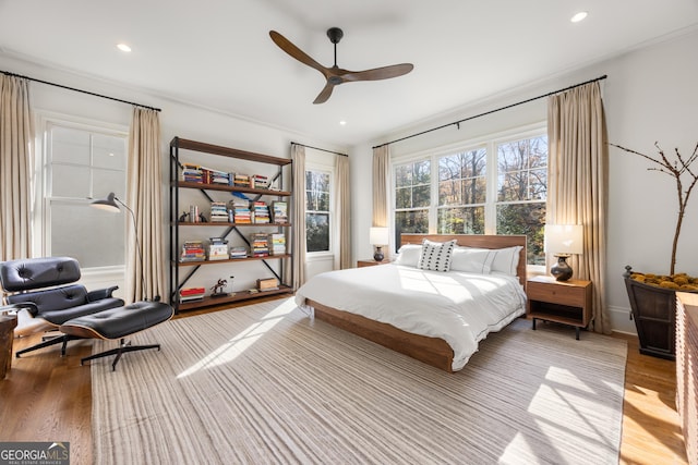 bedroom with ceiling fan and light wood-type flooring