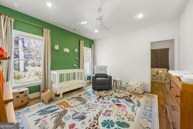 bedroom with wood-type flooring and ceiling fan