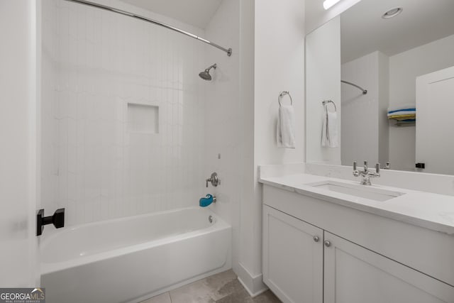 bathroom featuring vanity, tile patterned flooring, and tiled shower / bath