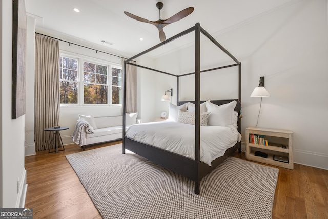 bedroom featuring crown molding, hardwood / wood-style floors, and ceiling fan