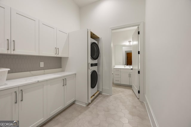 washroom featuring stacked washer / dryer