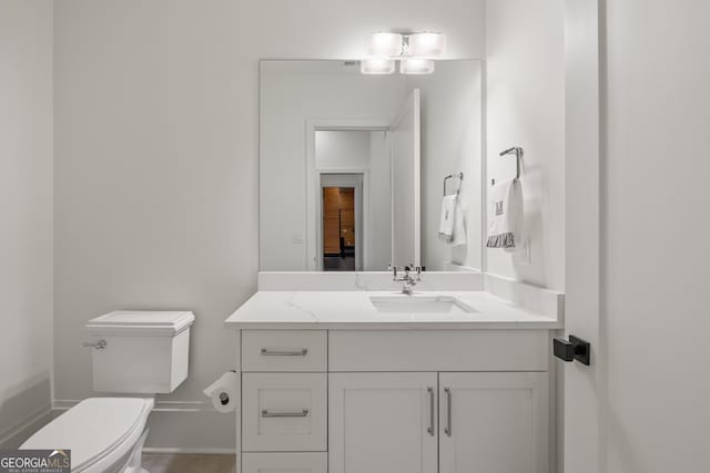 bathroom featuring vanity and toilet