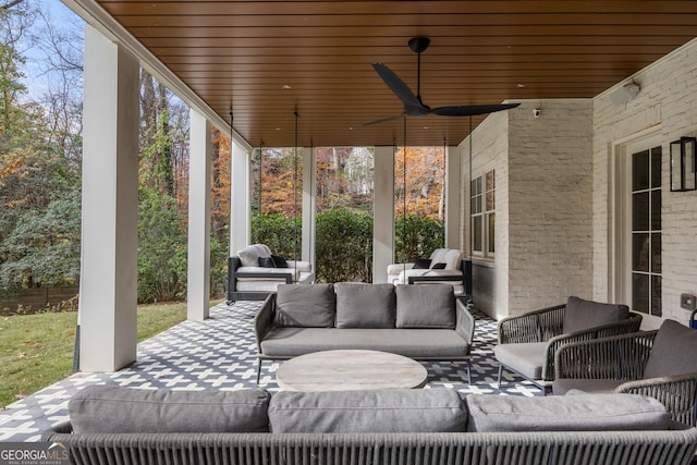 view of patio with an outdoor living space and ceiling fan