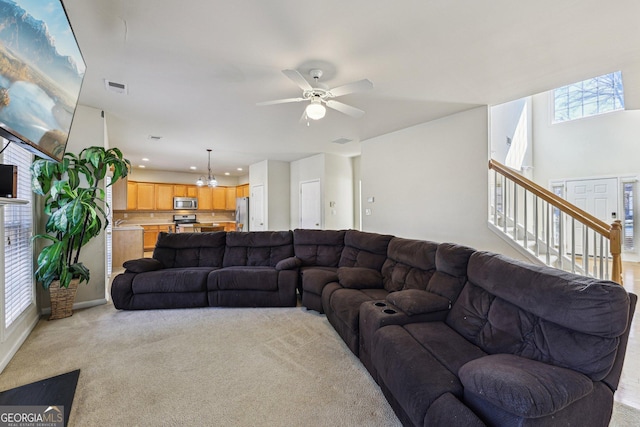 carpeted living room featuring ceiling fan